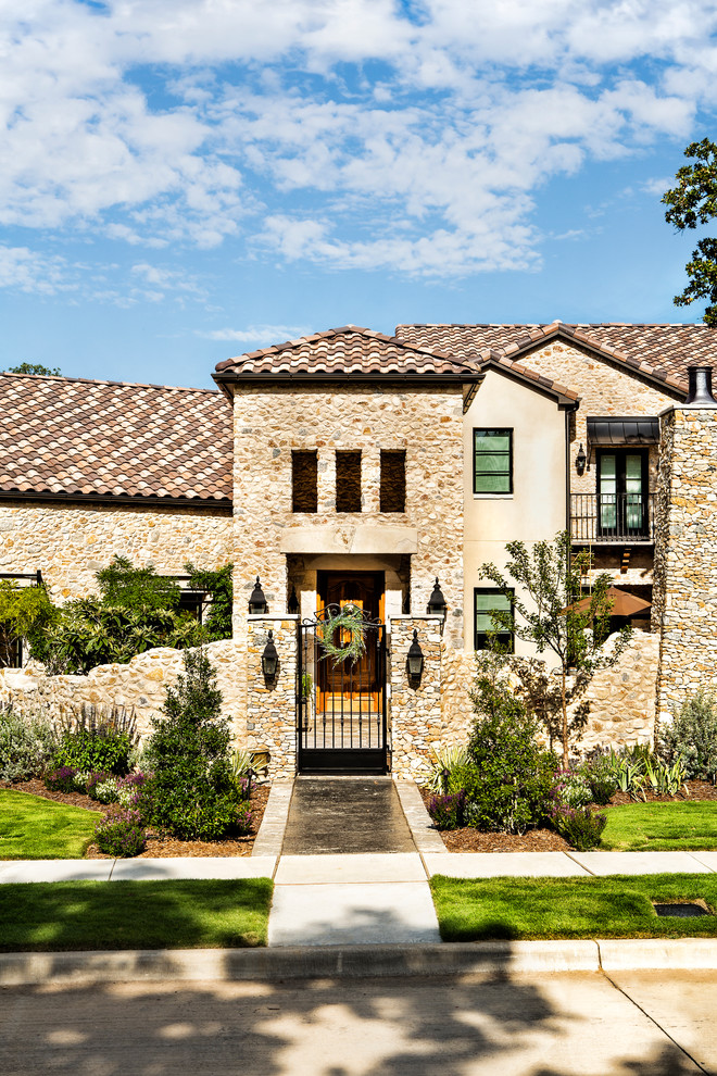 Inspiration for a large country beige two-story mixed siding exterior home remodel in Dallas with a hip roof