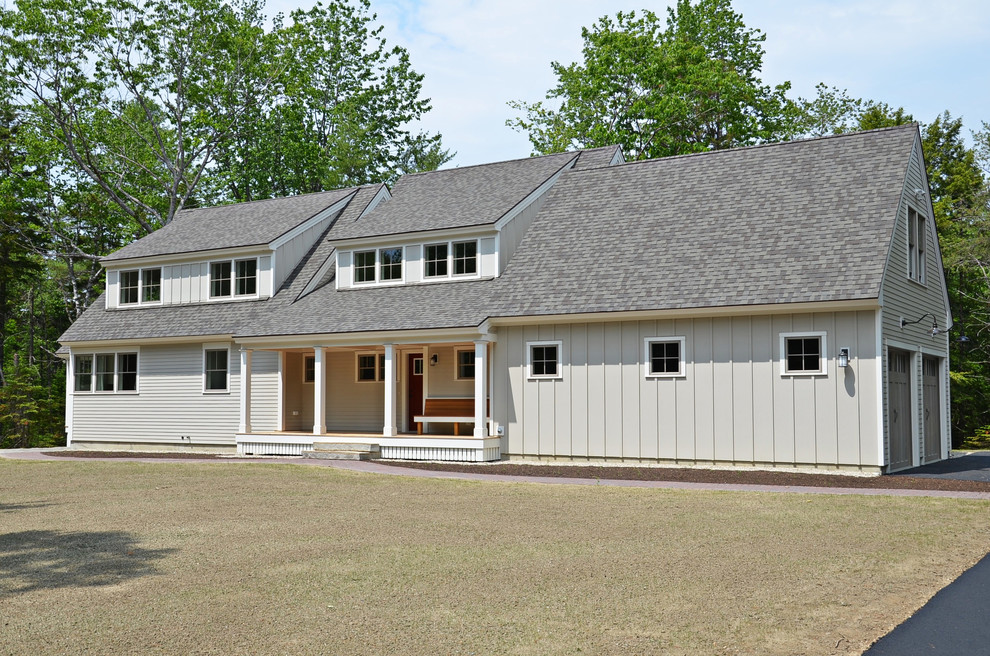 Mittelgroßes, Zweistöckiges Landhaus Einfamilienhaus mit Metallfassade, beiger Fassadenfarbe, Satteldach und Schindeldach in Sonstige