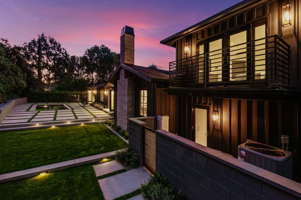Example of a large farmhouse black split-level wood house exterior design in Los Angeles