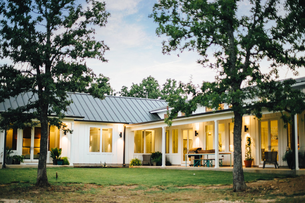 Esempio della casa con tetto a falda unica bianco country a un piano di medie dimensioni