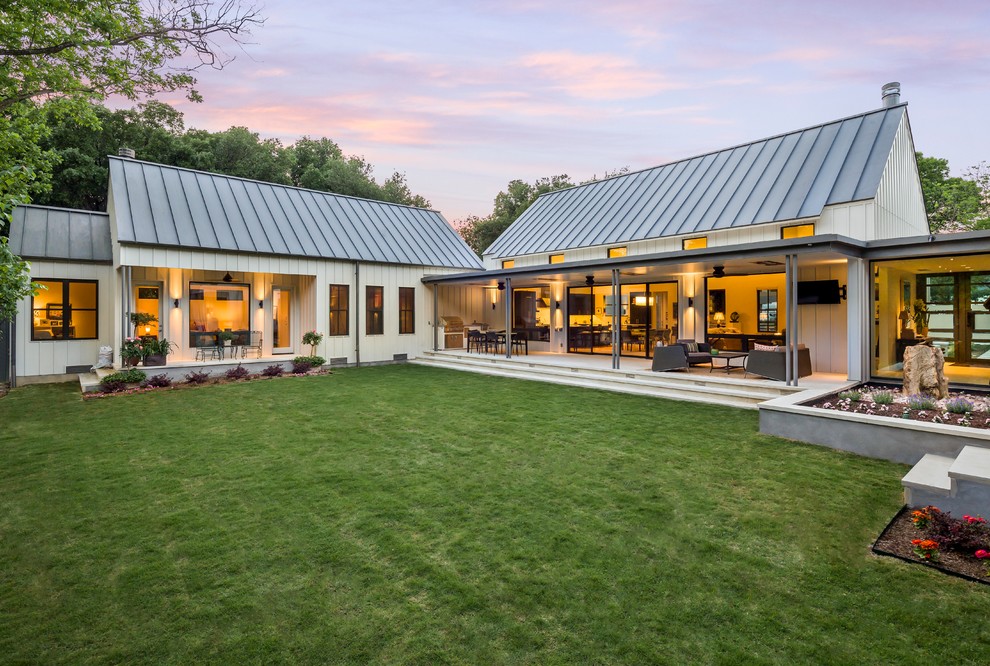 Example of a farmhouse white one-story wood exterior home design in Dallas