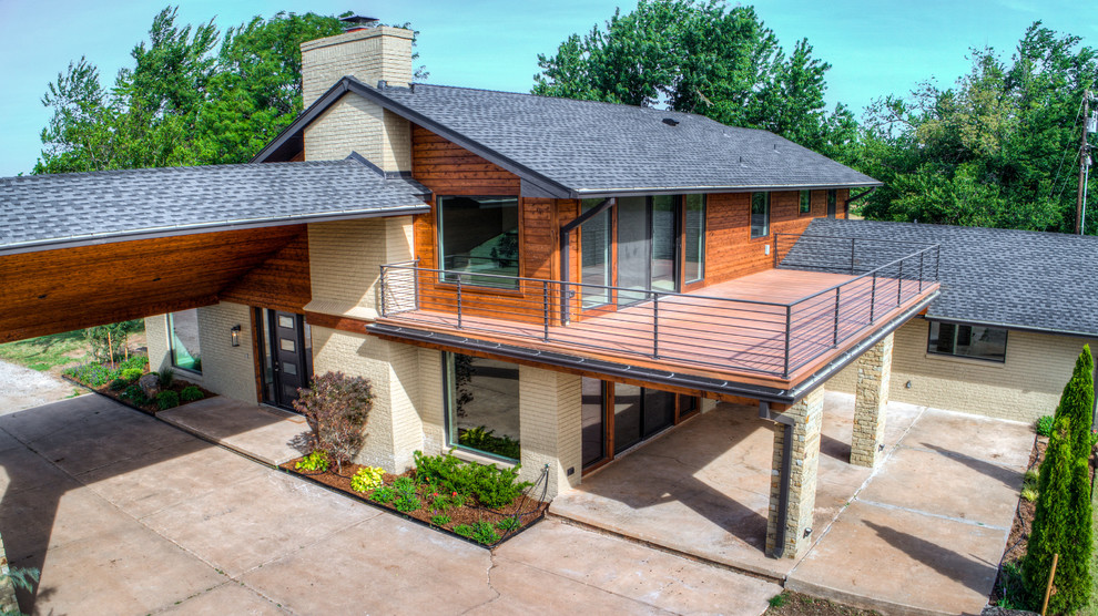 Photo of a medium sized and beige country bungalow detached house in Oklahoma City with mixed cladding, a pitched roof and a tiled roof.