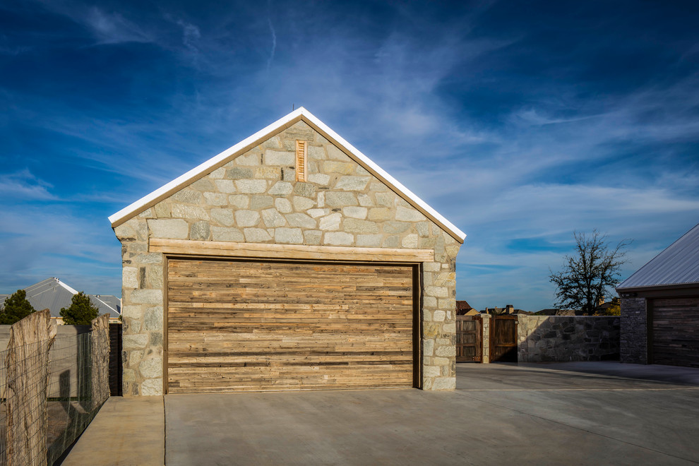 Diseño de fachada gris de estilo de casa de campo con revestimiento de piedra y tejado a dos aguas