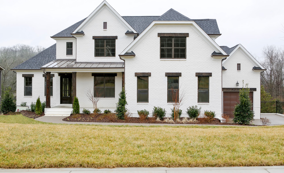 Diseño de fachada blanca de estilo de casa de campo grande de dos plantas con revestimiento de ladrillo