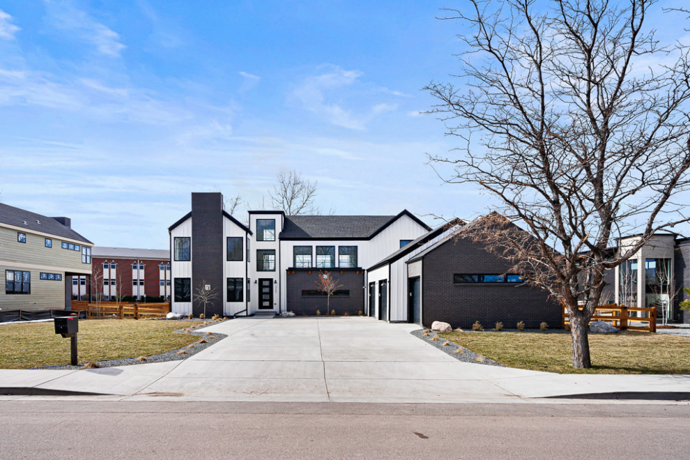 Zweistöckiges Modernes Einfamilienhaus mit Backsteinfassade, weißer Fassadenfarbe, Satteldach, Schindeldach, schwarzem Dach und Wandpaneelen in Denver