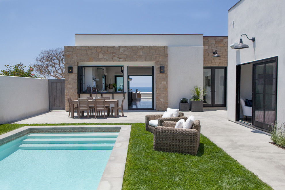 Inspiration for a contemporary beige one-story exterior home remodel in Orange County