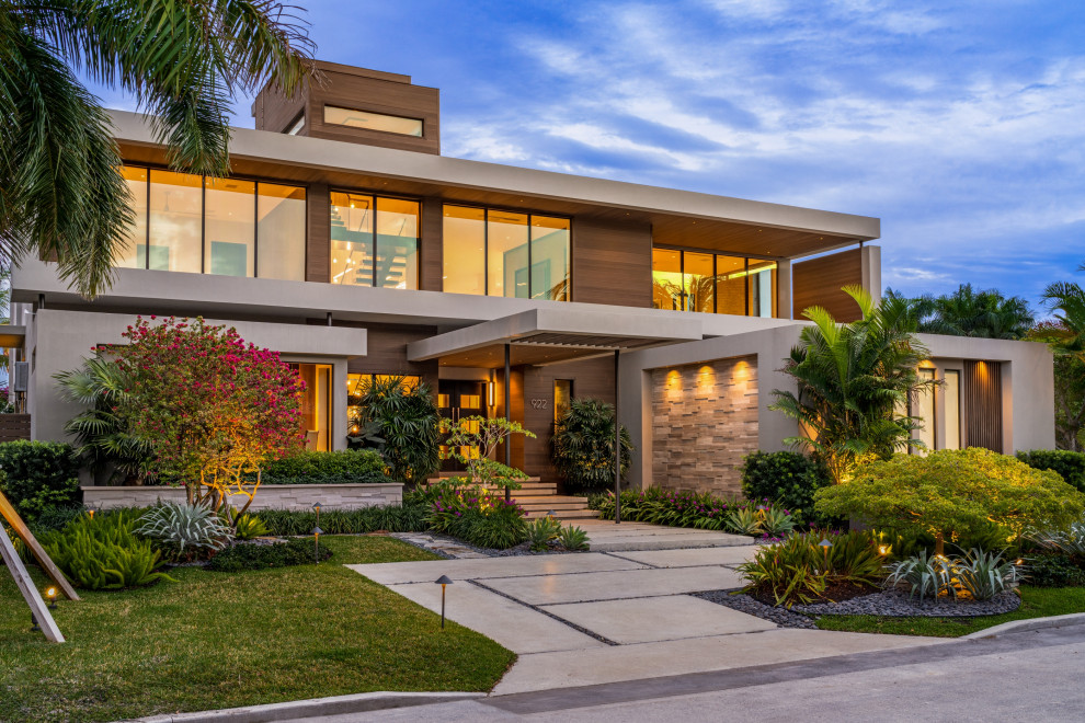 Large trendy brown two-story wood exterior home photo in Miami