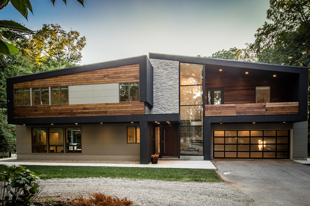 Example of a large trendy brown two-story mixed siding exterior home design in Philadelphia with a shed roof
