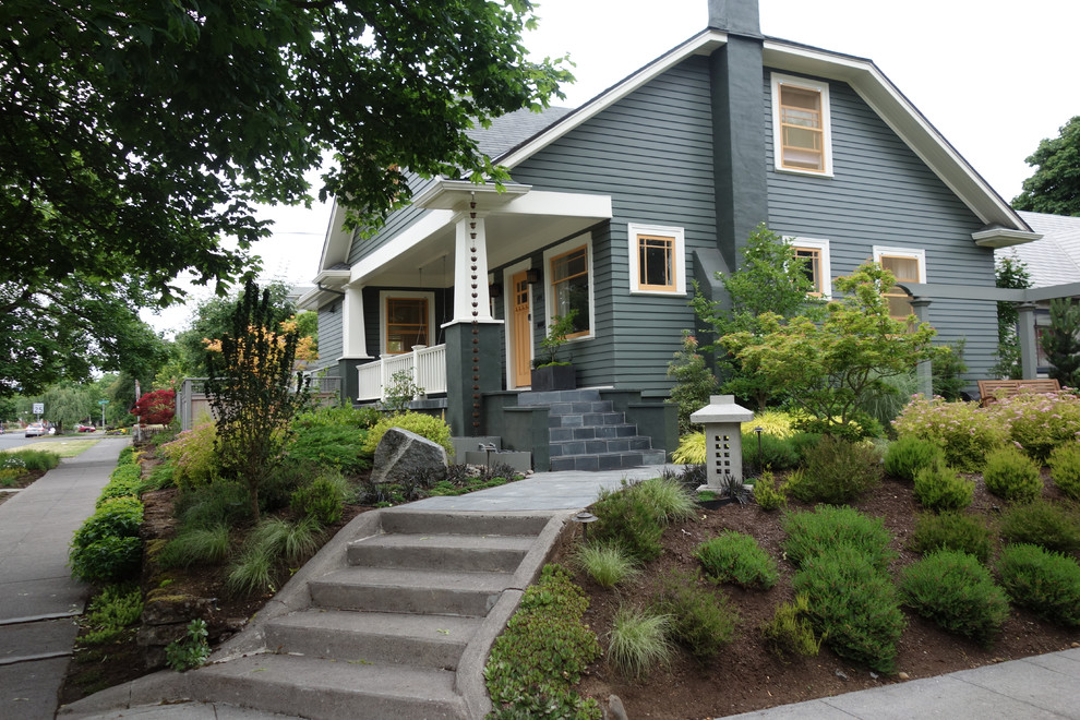 Photo of a large and green industrial bungalow house exterior in Portland with wood cladding.