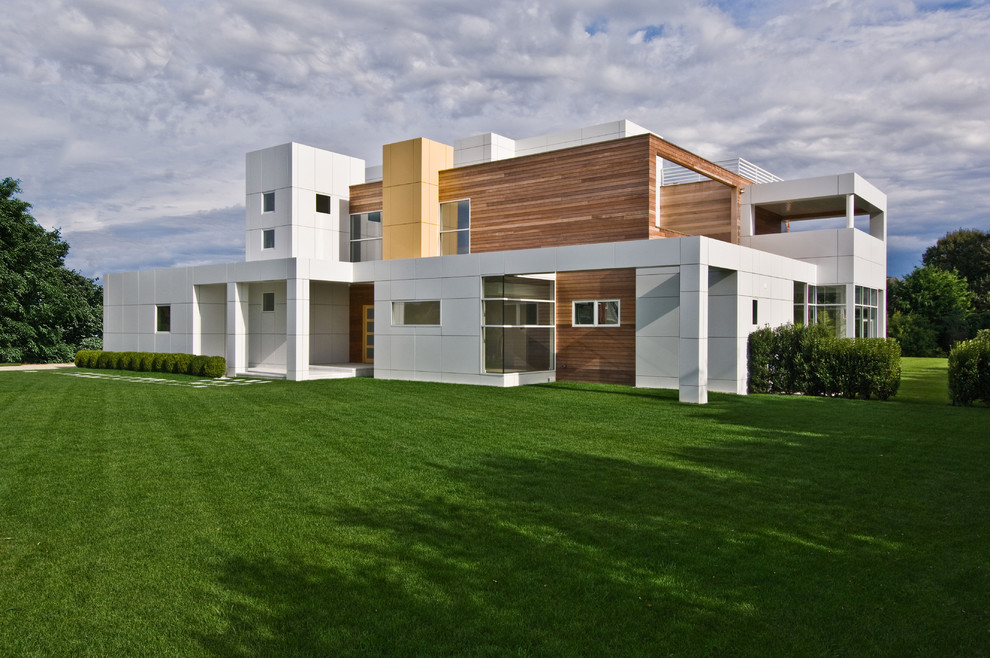 This is an example of a contemporary two floor house exterior in New York with mixed cladding and a flat roof.