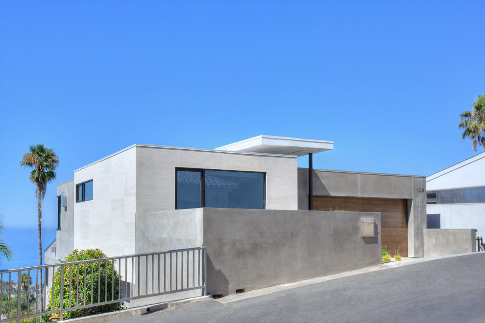 Example of a mid-sized beach style gray two-story exterior home design in Orange County with a metal roof