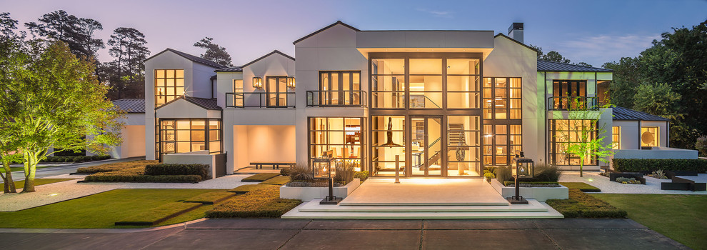 This is an example of an expansive and white modern two floor render house exterior in Houston.