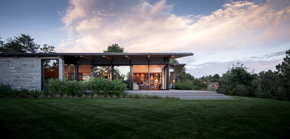 Inspiration pour une façade de maison grise design de plain-pied avec un toit plat.