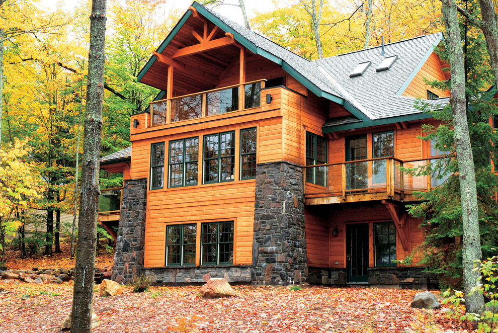 Large traditional brown three-story wood house exterior idea in Other with a hip roof and a shingle roof