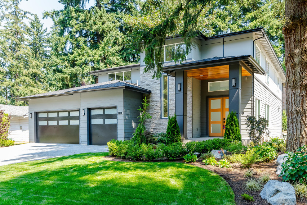 Inspiration for a contemporary gray two-story house exterior remodel in Seattle with a hip roof, a shingle roof and a gray roof
