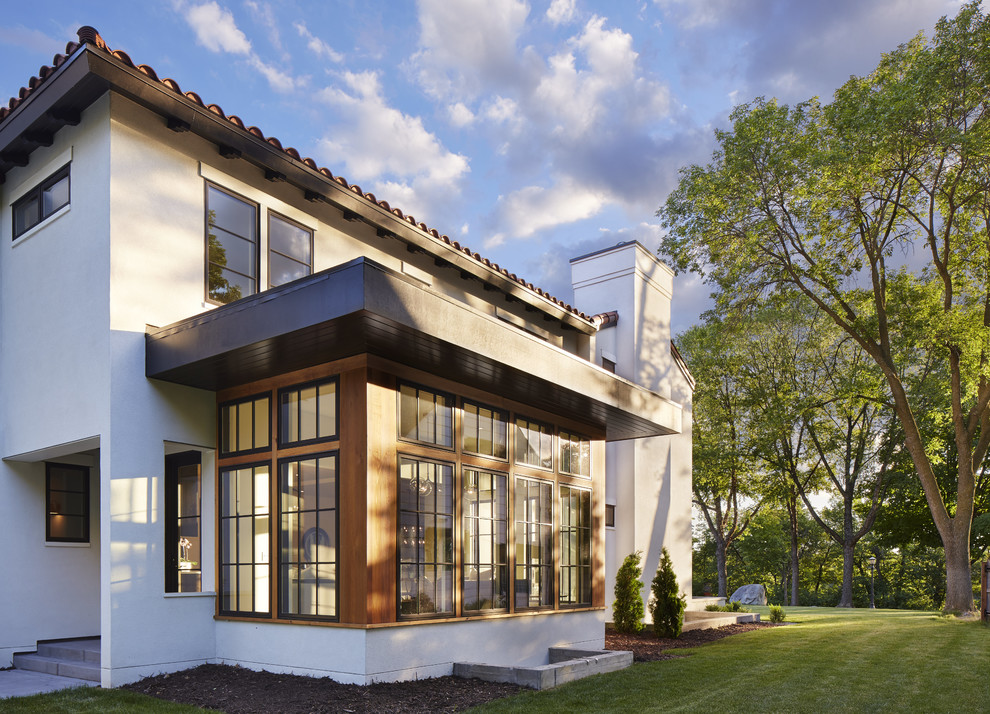 Mediterranean white two-story stucco exterior home idea in Minneapolis