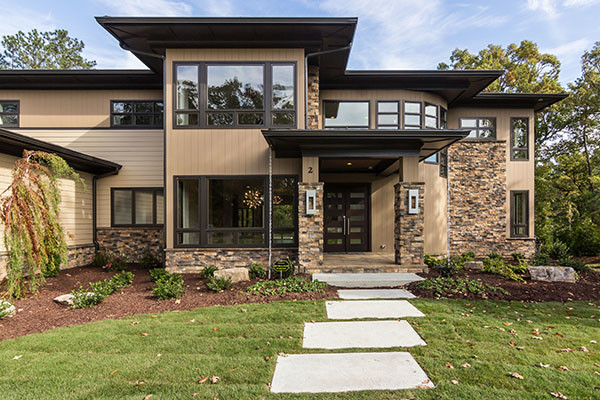 Inspiration for a modern house exterior in Raleigh with stone cladding.