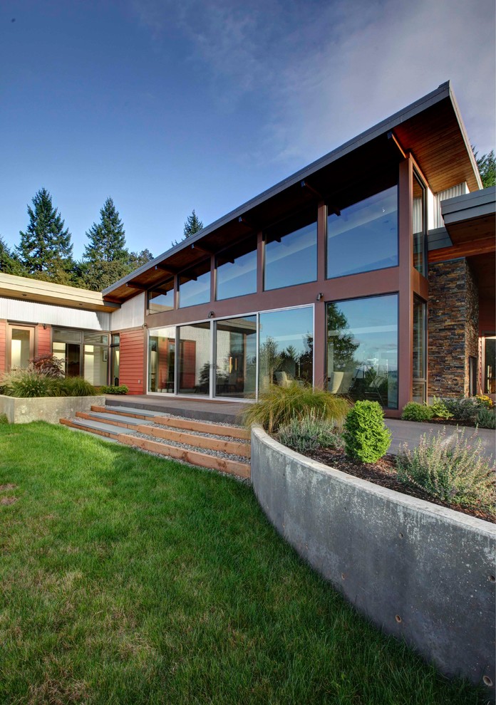 Photo of a red contemporary bungalow house exterior in Portland with metal cladding.