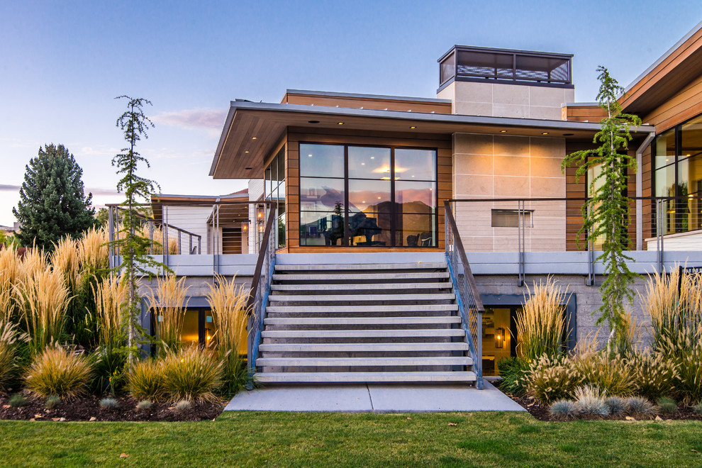 Large minimalist white two-story wood exterior home photo in Salt Lake City with a mixed material roof