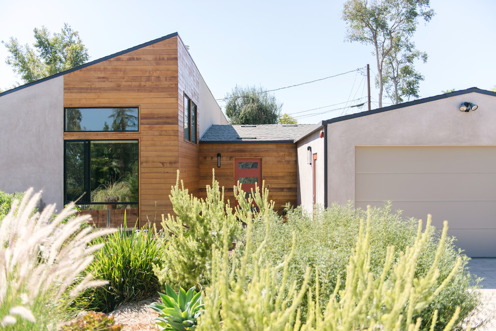 Inspiration for a mid-sized modern gray one-story wood exterior home remodel in Los Angeles with a shed roof
