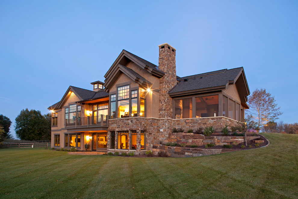 Inspiration for a large rustic beige two-story mixed siding exterior home remodel in Minneapolis with a shingle roof