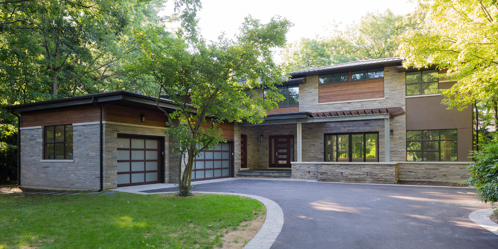 Example of a large trendy two-story stone exterior home design in Toronto