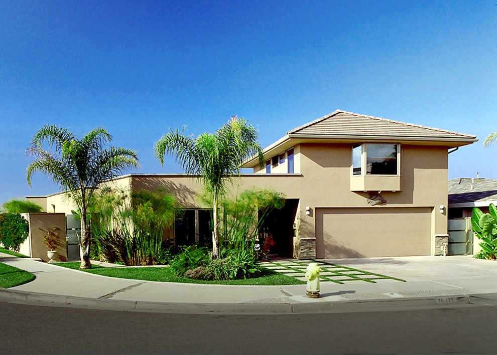 Huge minimalist beige two-story stucco exterior home photo in Orange County