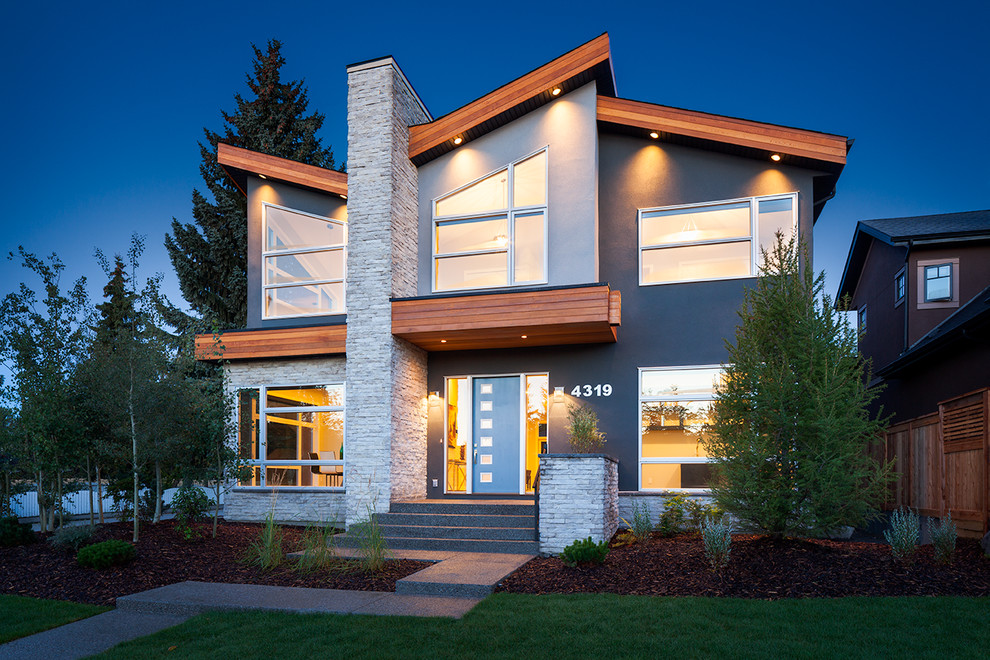 Large modern blue two-story mixed siding exterior home idea in Calgary