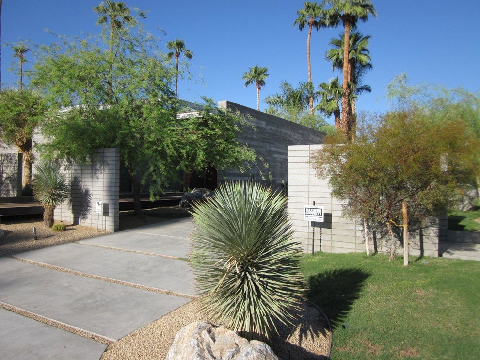 This is an example of a gey retro bungalow concrete house exterior in Orange County.