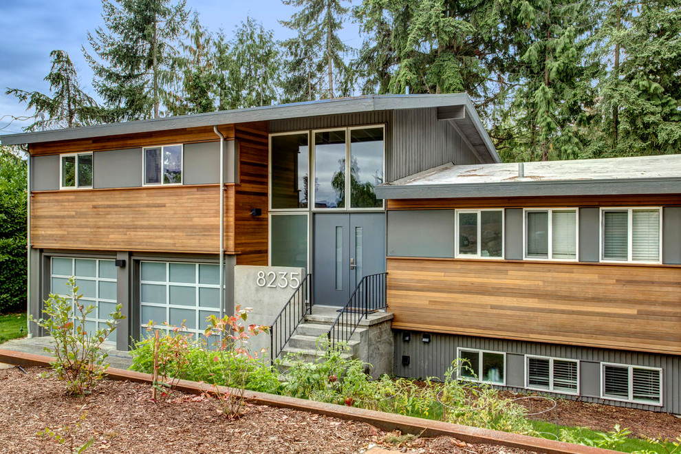 Inspiration for a gey modern house exterior in Seattle with wood cladding.