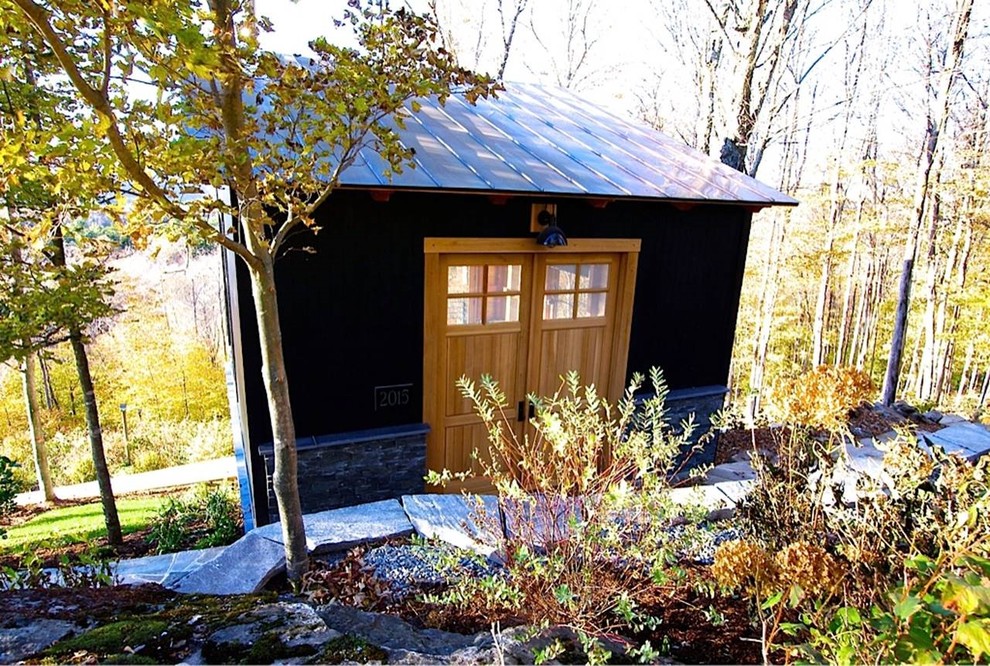 Photo of a small and gey modern house exterior in Burlington with wood cladding and a lean-to roof.