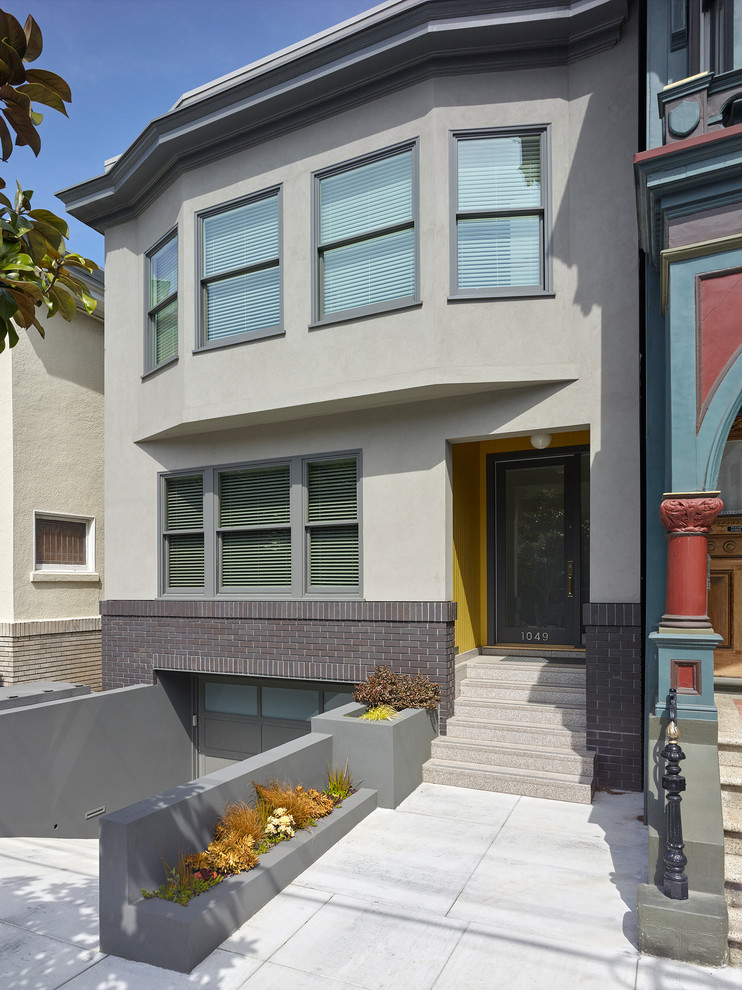 Example of a mid-sized transitional gray two-story concrete exterior home design in San Francisco