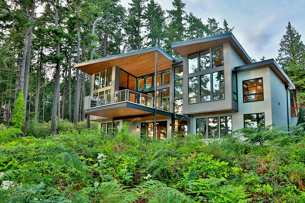 Inspiration för stora moderna flerfärgade hus, med två våningar, blandad fasad, pulpettak och tak i metall