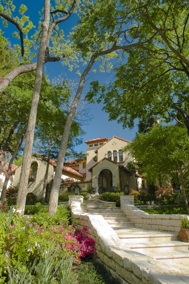 Photo of a mediterranean two floor house exterior in Dallas.