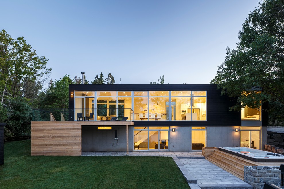 Zweistöckiges, Großes Modernes Haus mit Mix-Fassade, Flachdach und schwarzer Fassadenfarbe in Ottawa
