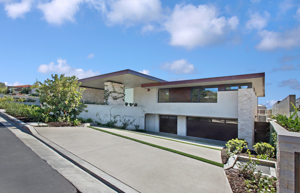 Inspiration for a mid-sized modern beige one-story stucco flat roof remodel in Orange County