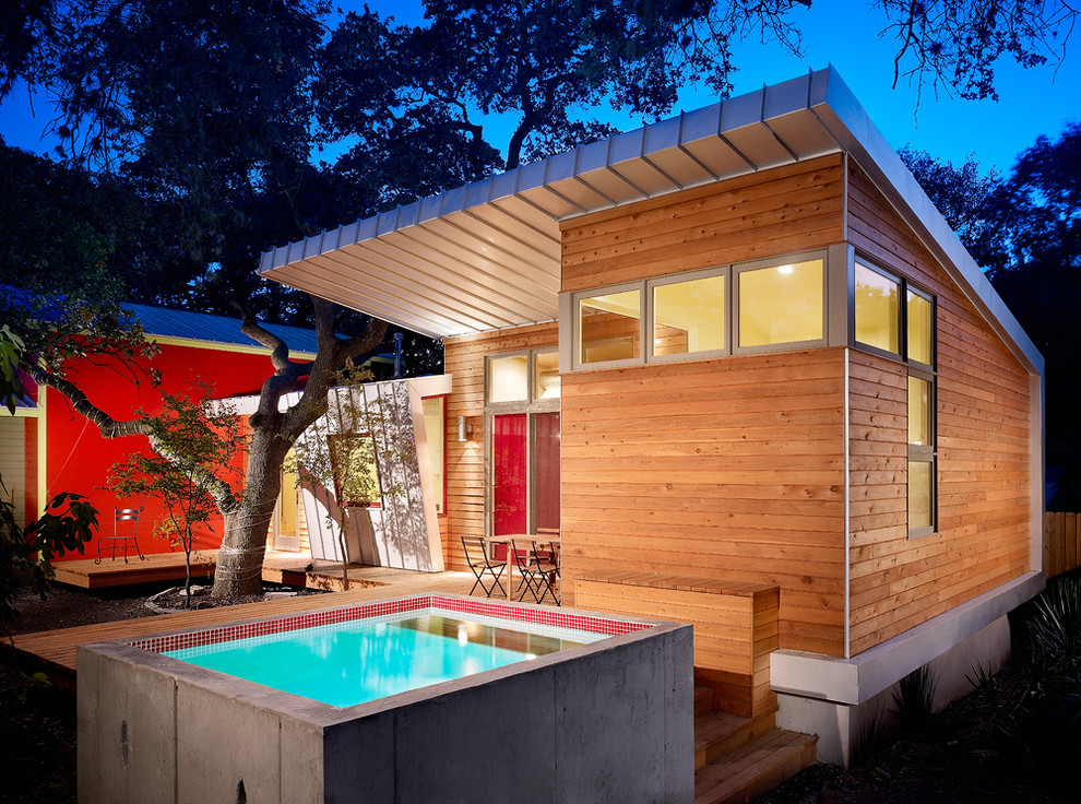 Modern wood exterior home idea in Austin with a shed roof