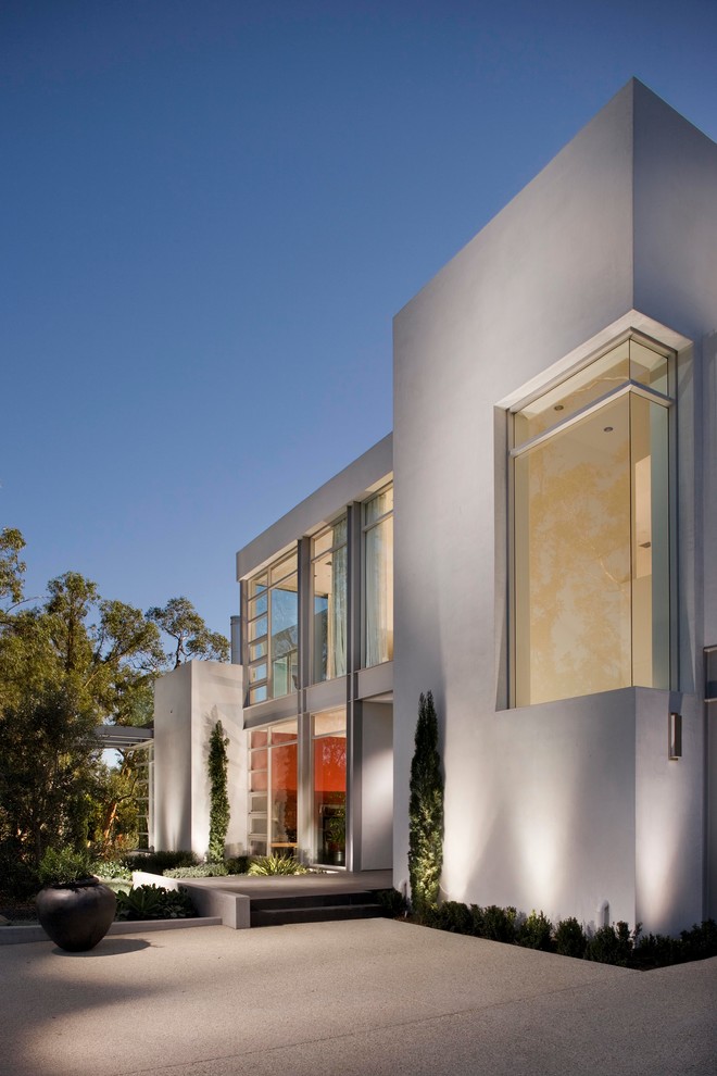 Imagen de fachada de casa blanca minimalista grande de dos plantas con revestimiento de estuco y tejado plano