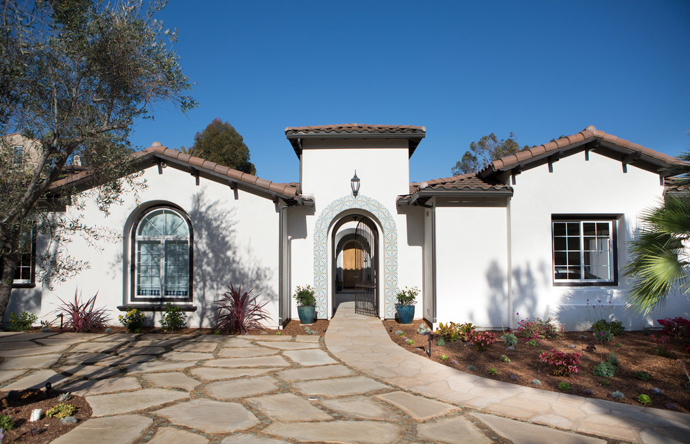 Design ideas for a large and white mediterranean bungalow render house exterior in San Diego.