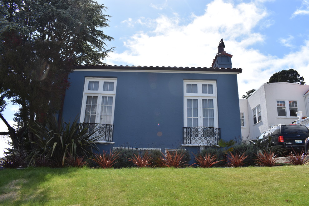 Exempel på ett stort medelhavsstil blått hus