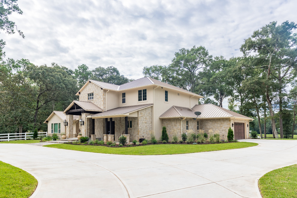 Inspiration for a large transitional beige two-story mixed siding house exterior remodel in Houston with a hip roof and a metal roof