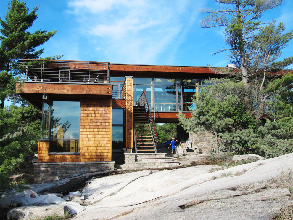 Inspiration for a modern glass house exterior in Toronto.