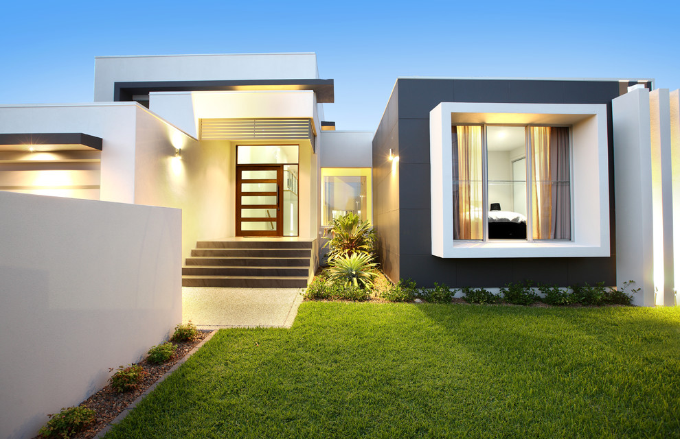 Réalisation d'une façade de maison design de taille moyenne et de plain-pied avec un toit plat.