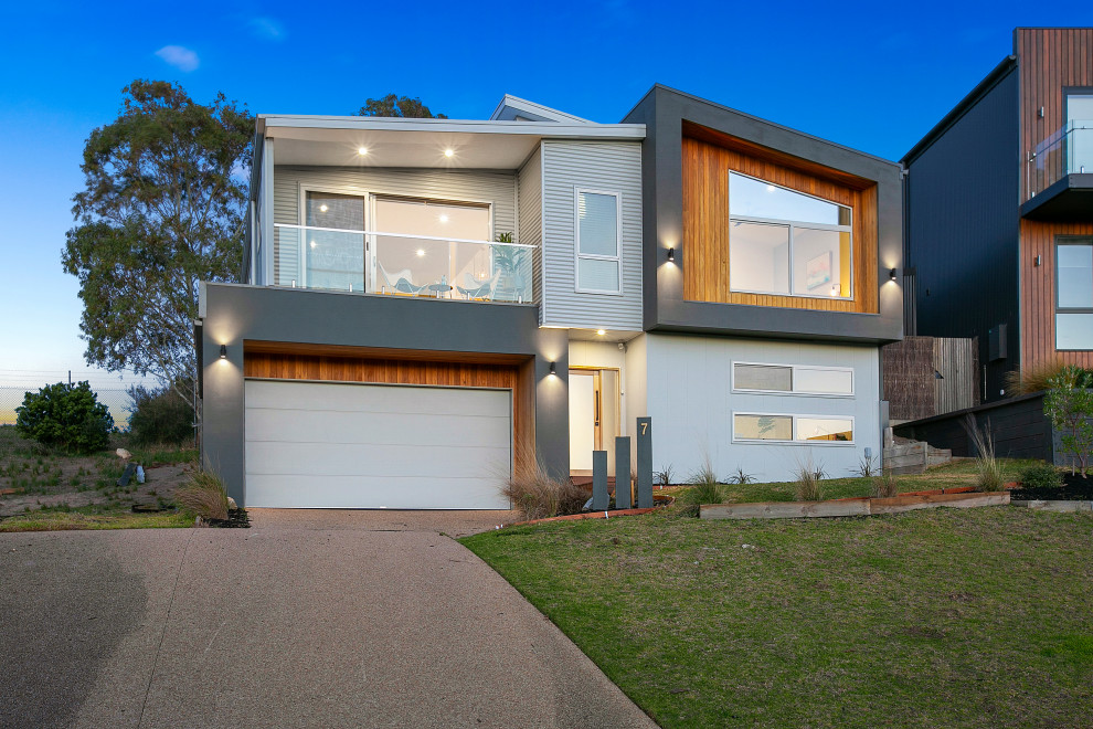 Mittelgroßes, Zweistöckiges Modernes Einfamilienhaus mit Mix-Fassade, grauer Fassadenfarbe, Flachdach und Blechdach in Melbourne