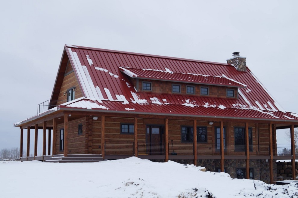 This is an example of a medium sized and brown rustic two floor house exterior in Minneapolis with a pitched roof.