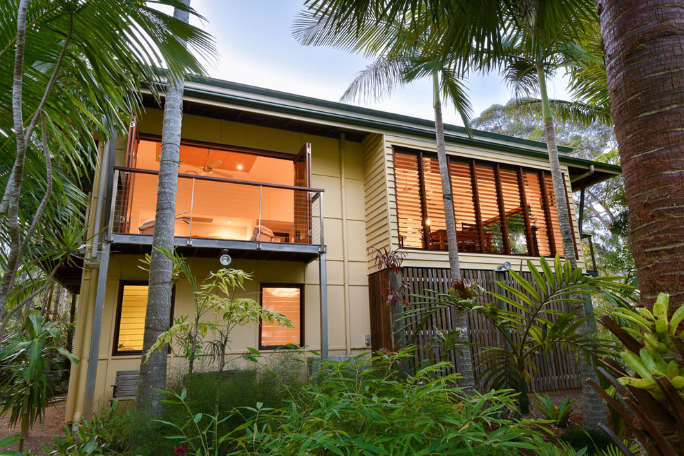 Modelo de fachada de casa multicolor exótica grande de dos plantas con tejado a cuatro aguas y tejado de metal