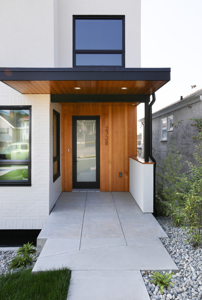 This is an example of a contemporary house exterior in Vancouver with three floors.