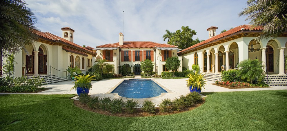 Large and white mediterranean two floor render house exterior in Tampa.