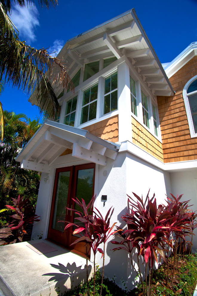 Large and white world-inspired two floor house exterior in Tampa with mixed cladding and a pitched roof.