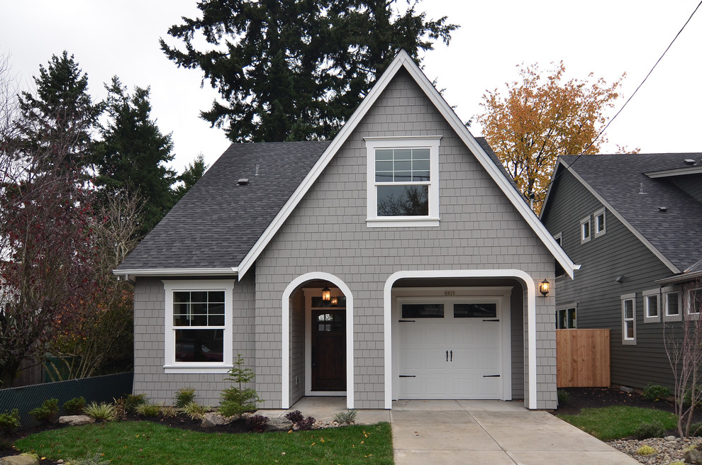 Medium sized traditional two floor house exterior in Portland with wood cladding.